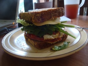 Freshly baked rye bread arugula, spinach, egg & cheese sandwich.