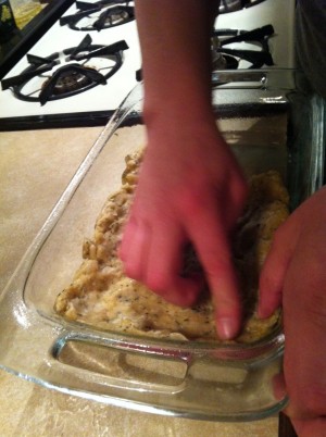pressing the dough into the baking dish